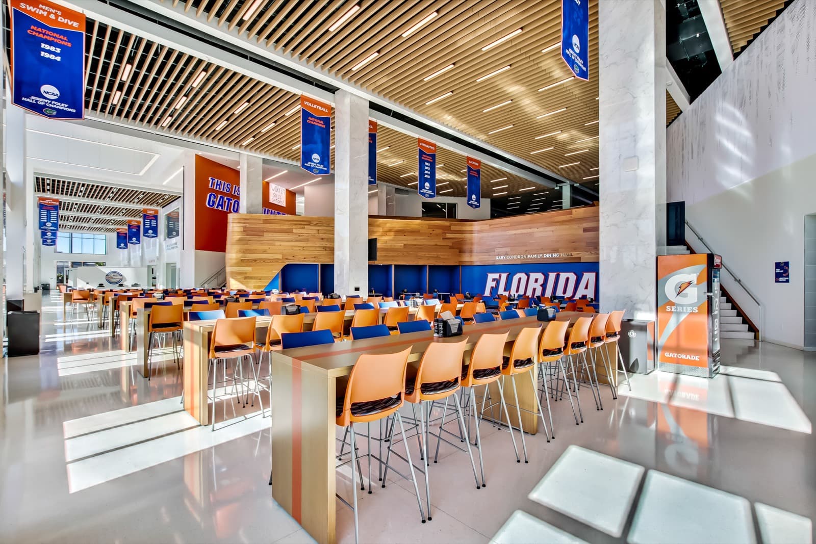 Bill Heavener Football Training Center — Hunter Douglas roller shades on full-height glazing