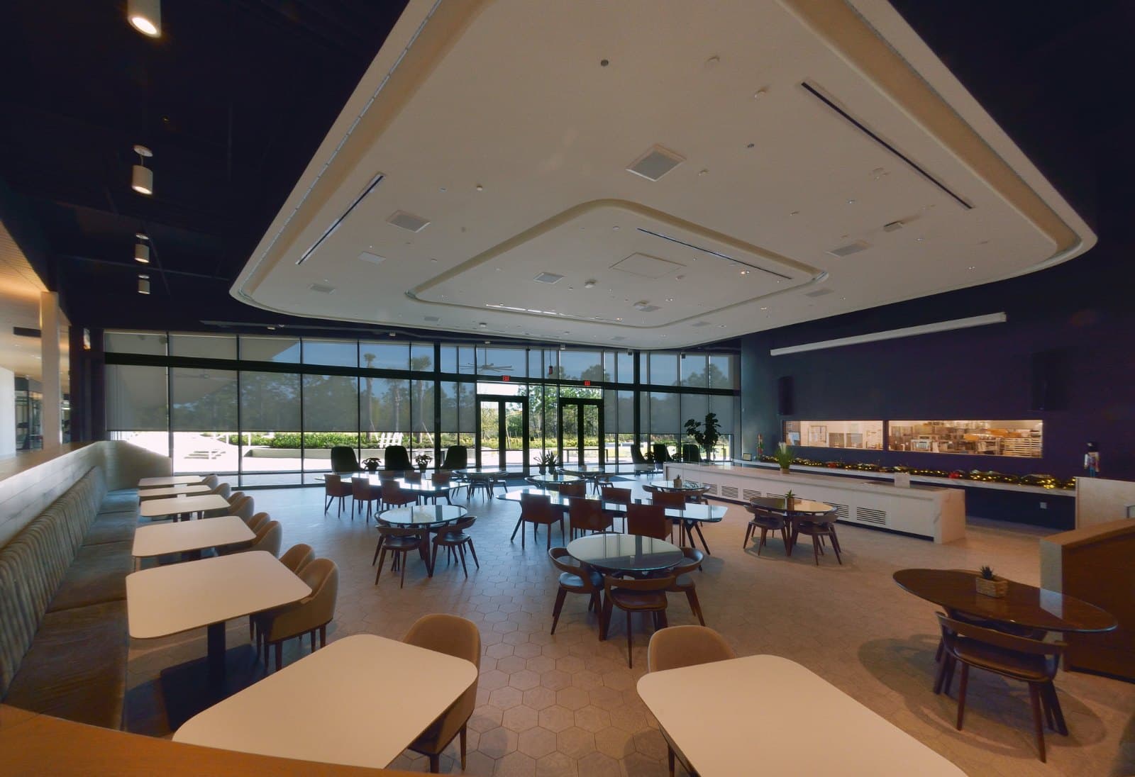 Johnson & Johnson HPI — dining hall with motorized roller shades on the window wall