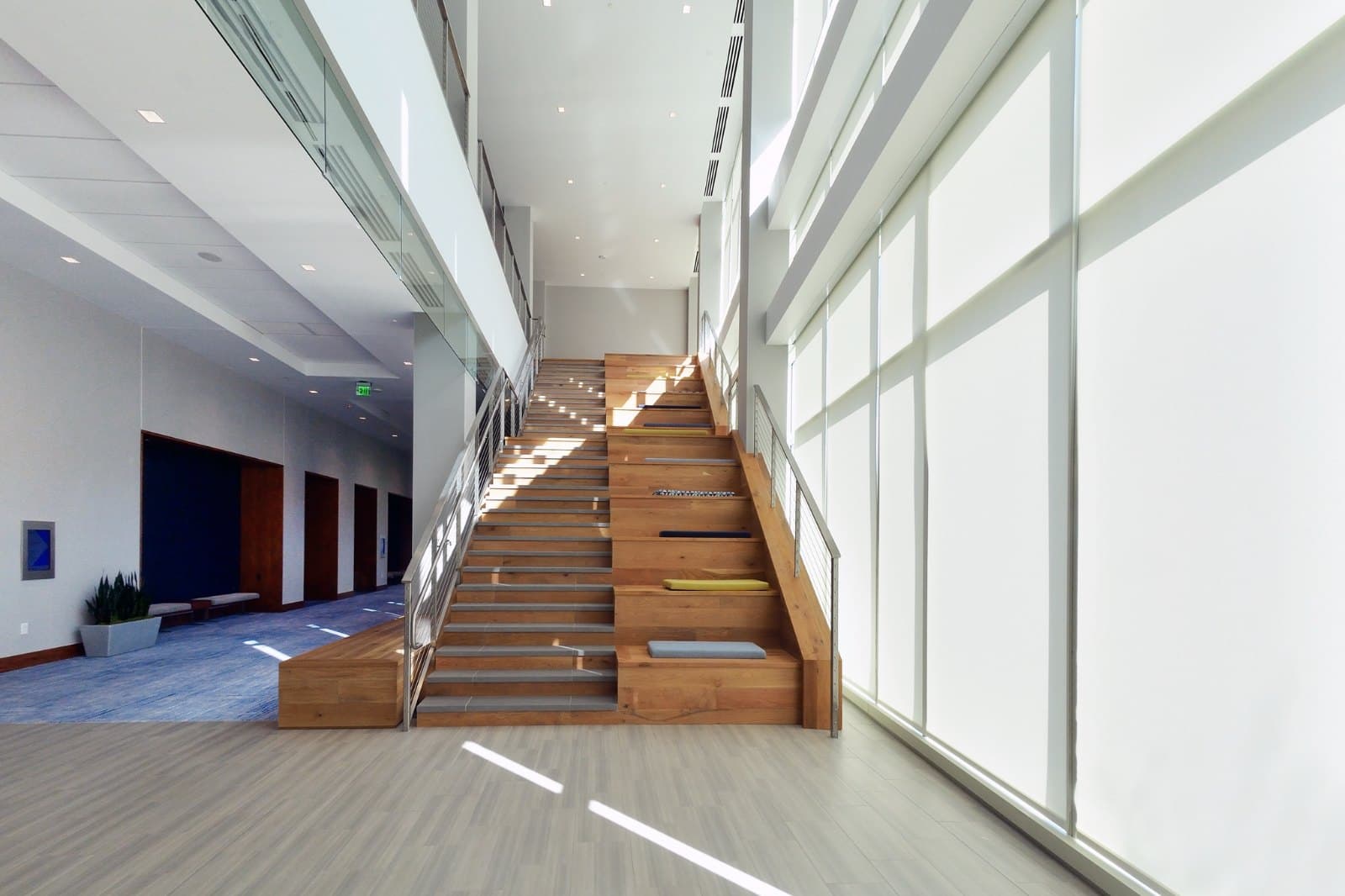 KPMG Lakehouse — motorized sheer roller shades on the full-height stair-hall glazing, Lake Nona, Orlando